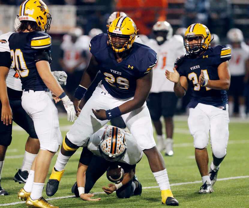 TXHSFB Arlington Lamar senior defensive lineman Bobby Brown (29) is congratulated by...