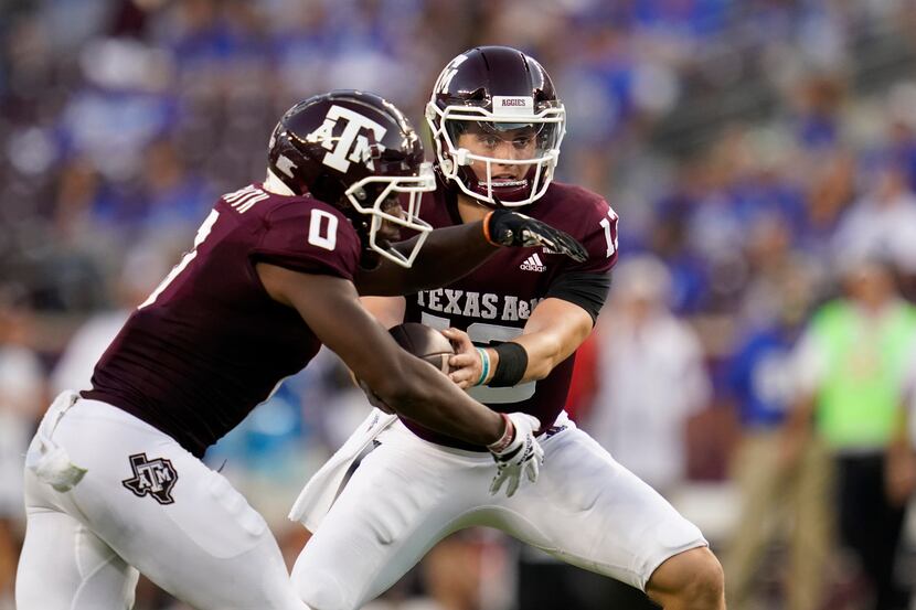 Texas A&M quarterback Haynes King (13) hands the ball off to Texas A&M wide receiver Ainias...