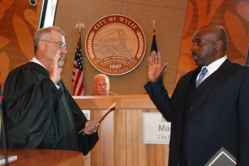 Bennie Jones is sworn in by Judge Terry Douglas as a new Wylie City Council member in 2012.