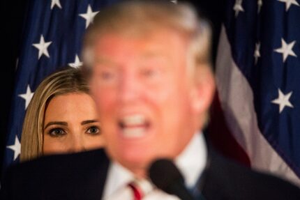 Ivanka Trump stands behind her father, Donald Trump, as he speaks at a campaign event in...