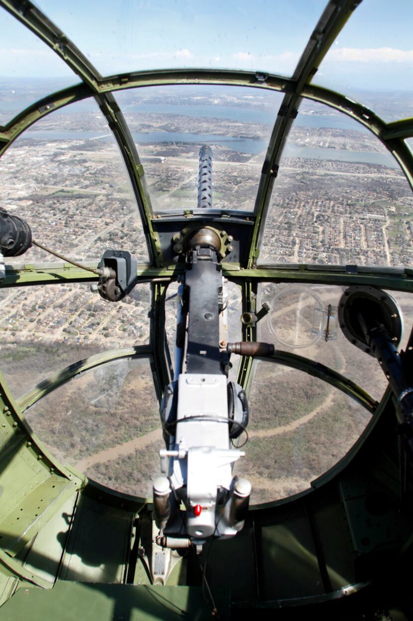 The view looking over a .30 caliber machine gun from the bombardier/navigator seat in the...