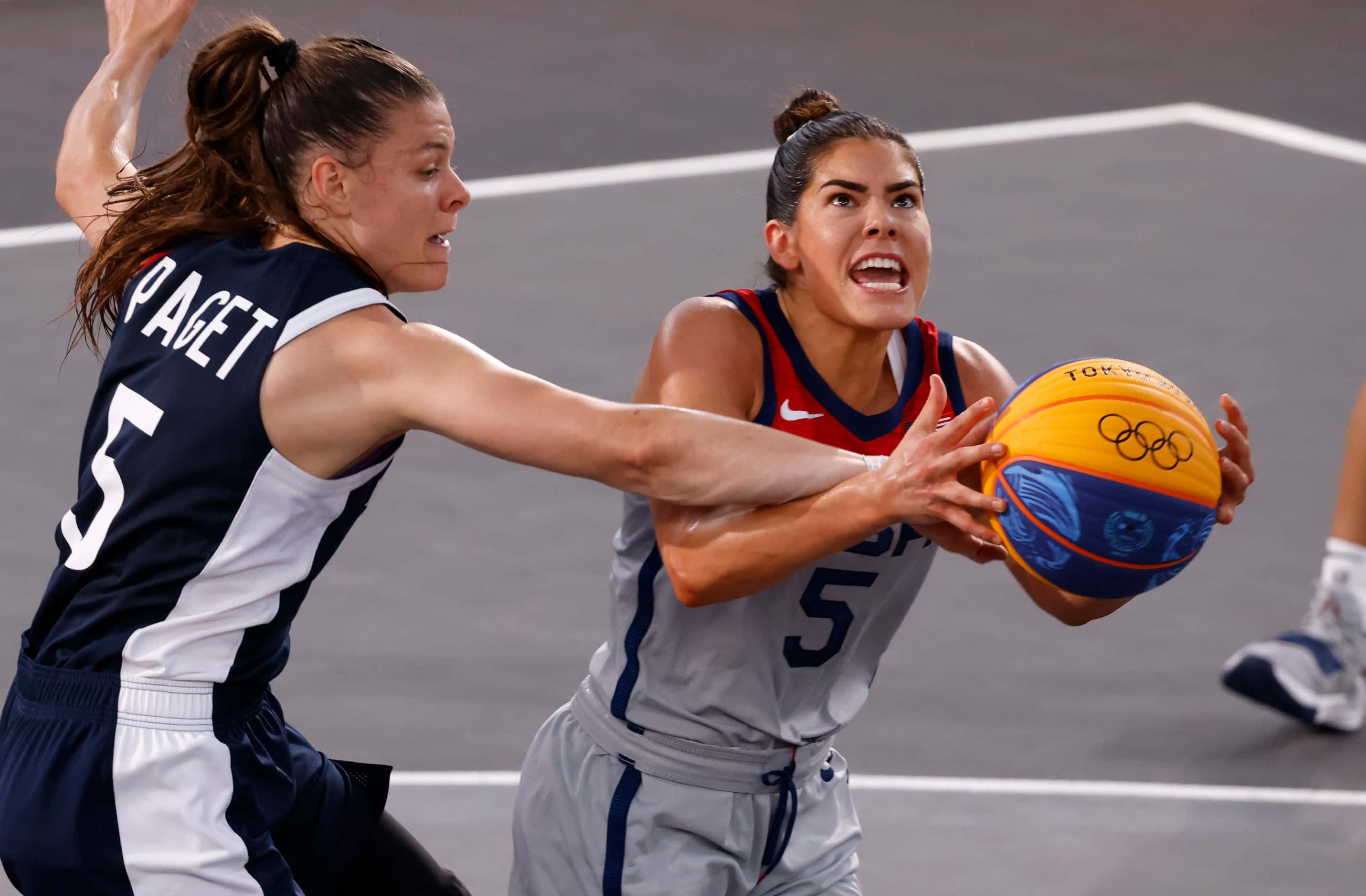 USA Kelsey Plum (5) is fouled as she attempts a shot in front of France’s Marie-Eve Paget...