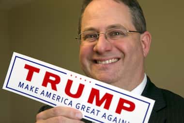 In this Jan. 11, 2017, photo, Trey Trainor poses with a Trump campaign sticker at the...