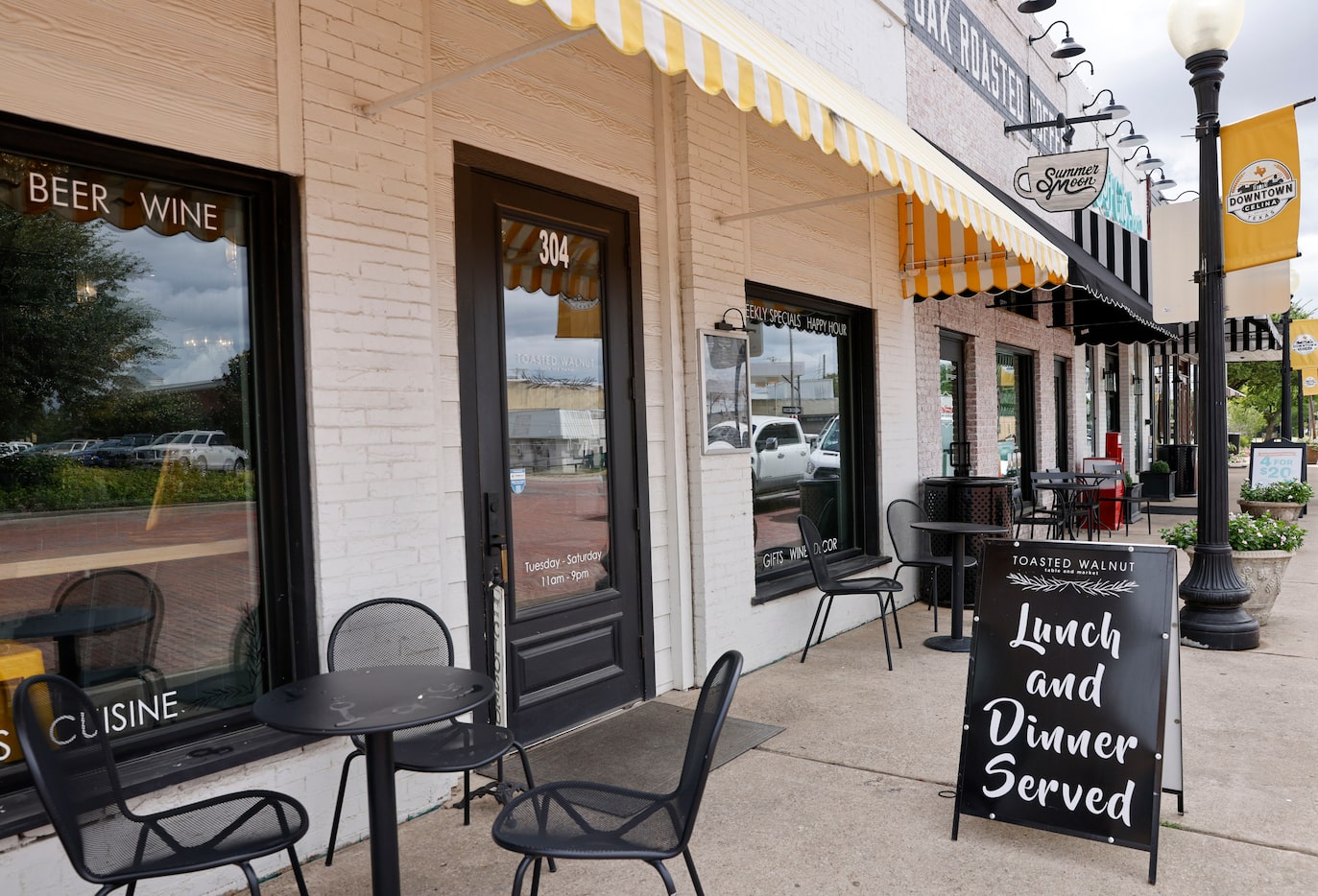 Tables and chairs line the outside of Toasted Walnut Table and Market in the Celina town...