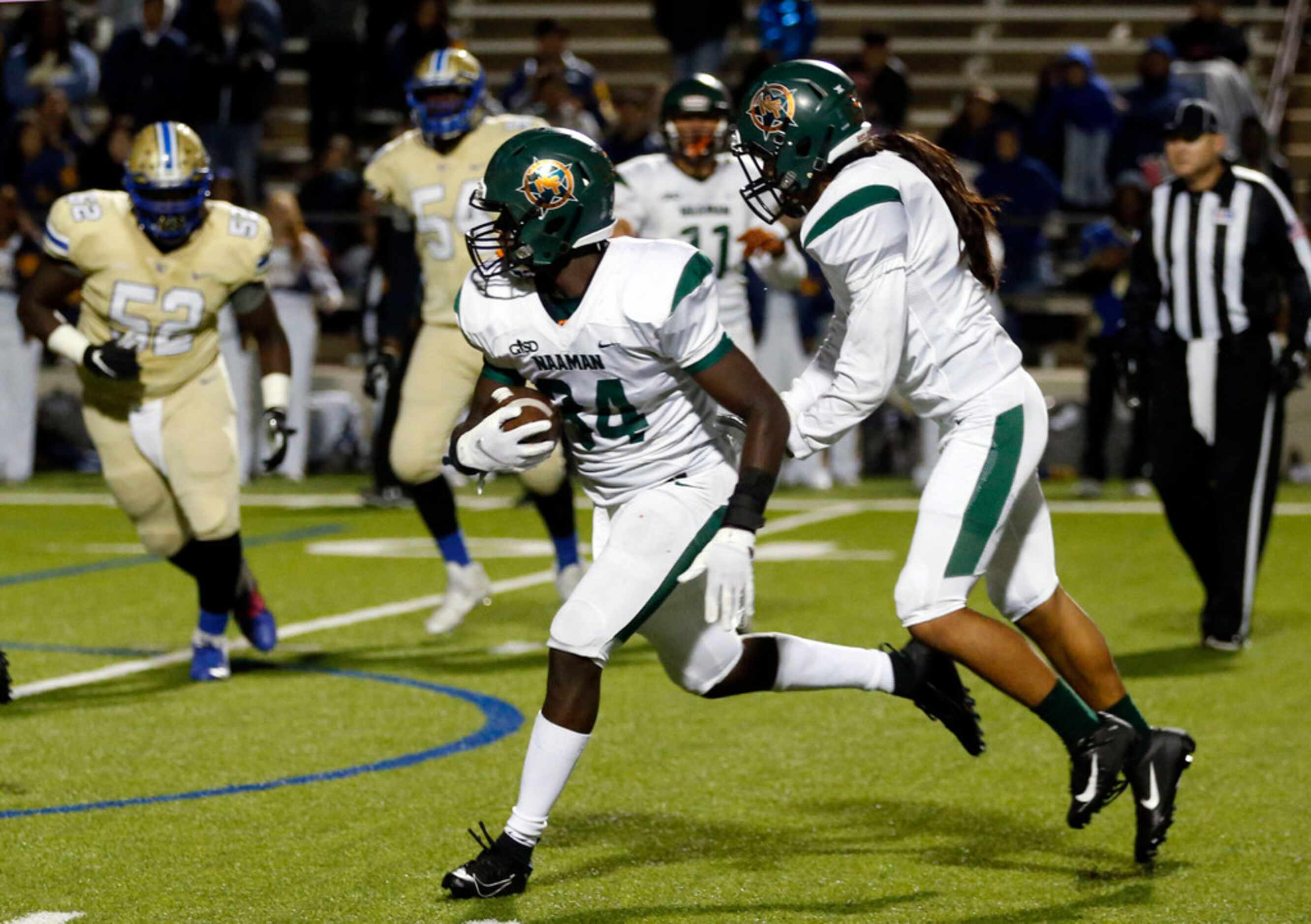 Naaman Forest defender Adrian Brown (34) returns an interception for a touchdown to seal the...
