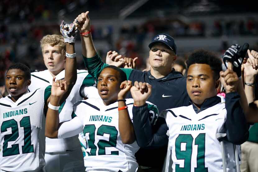 Waxahachie head coach Jon Kitna joins his players in the alma mater following their loss to...