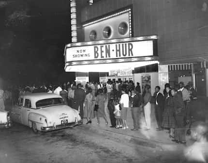 In the 19502, Black residents of South Dallas stand outside Forest Theater, with Ben-Hur on...