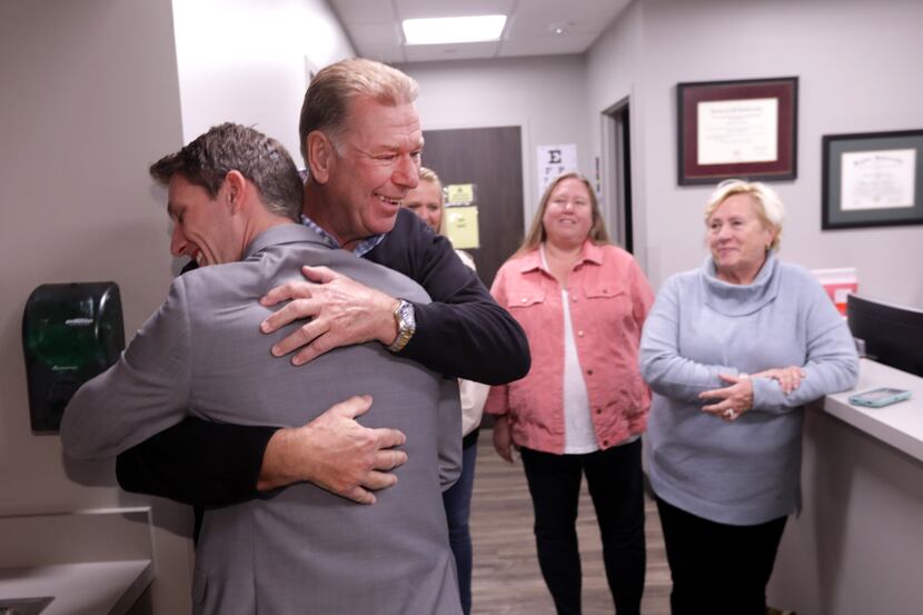 Dr. Andrew Parker, left, and Dennis Bennett embrace after meeting at Allen Orthopedics and...