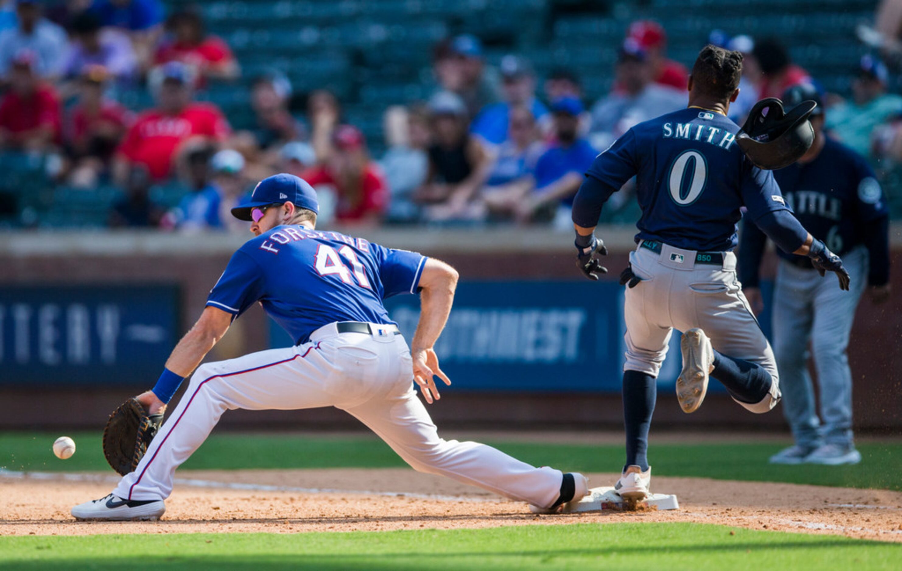 Seattle Mariners right fielder Mallex Smith (0) makes it to first ahead of a throw to Texas...