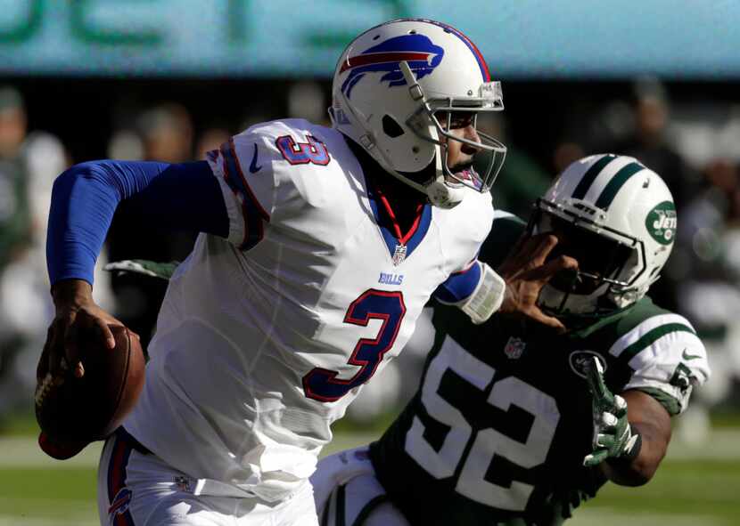 Buffalo Bills quarterback EJ Manuel (3) applies a stiff arm on New York Jets middle...