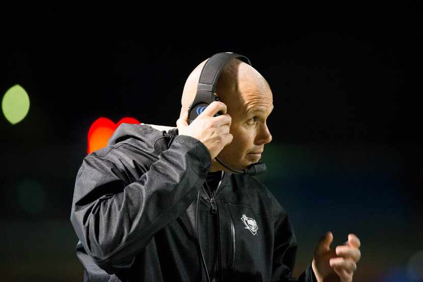 Wylie East head coach Joe Lepsis adjusts his headset during the second half of a UIL area...