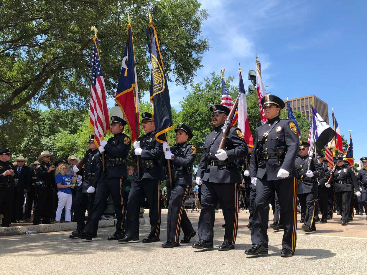 Members of the color guard walk away from the Capitol as the Texas Peace Officers' Memorial...
