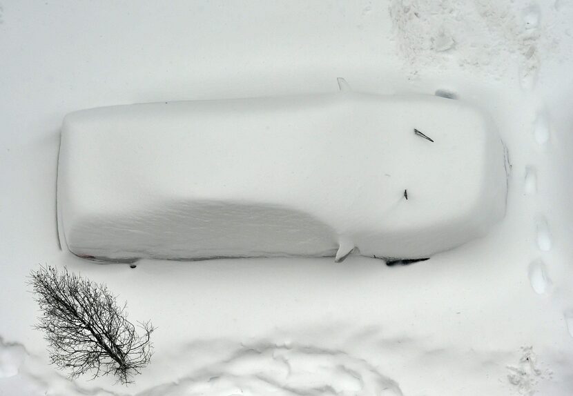  A snow covered car is seen from the roof of a building in Washington on January 23, 2016....