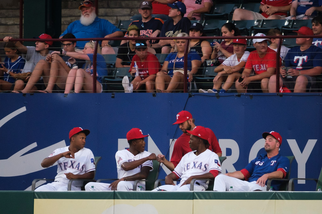 Texas Rangers relief pitcher Chris Martin (standing in red) says goodbye to teammates in the...