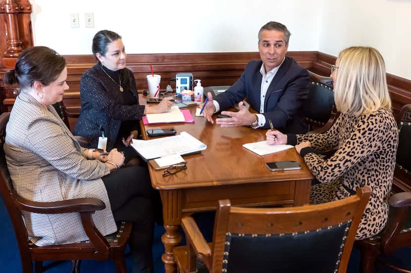 Luis Saenz, outgoing chief of staff for Texas Gov. Greg Abbott, meets with members of his...