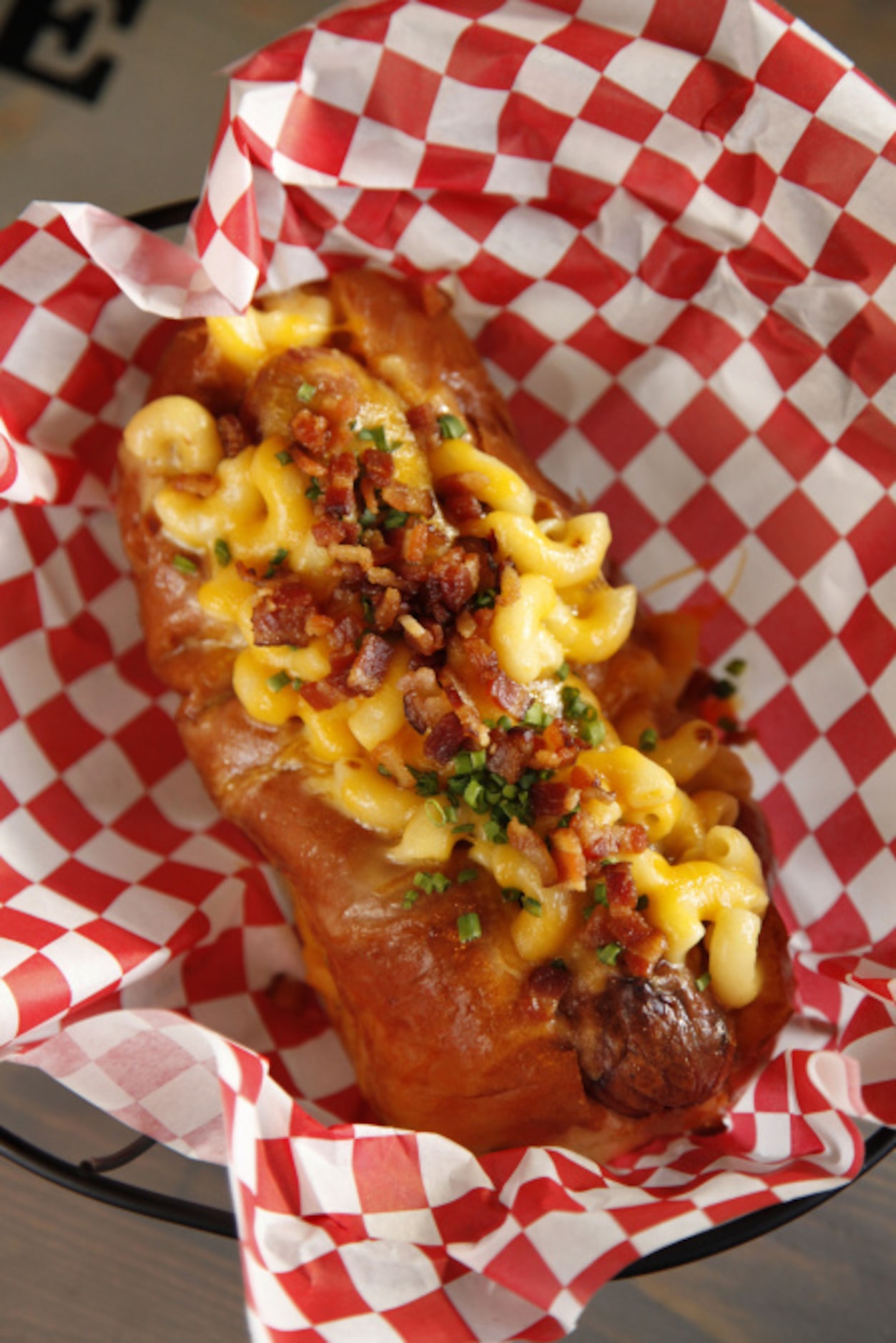 The Mac, a gourmet hot dog loaded with macaroni, bacon and chives, in a buttery, toasted bun...