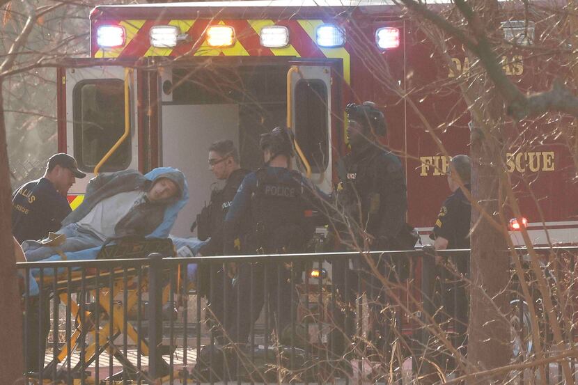 Kevin Knowles, 31, is loaded into an ambulance after a six-hour standoff in a drainage...