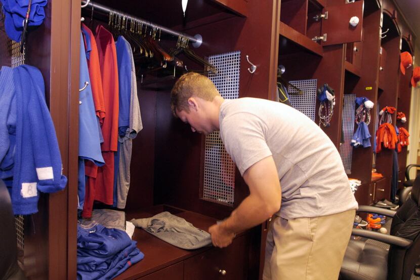 A Texas Rangers clubhouse attendent cleans out Matt Garza's locker Tuesday October 1, 2013...
