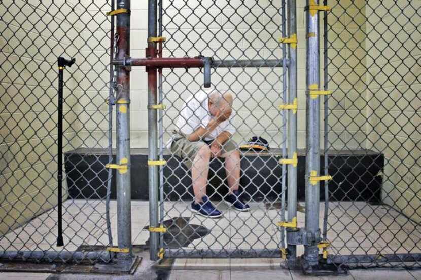 
A veteran with post-traumatic stress disorder sits in a holding pen at the Cook County Jail...