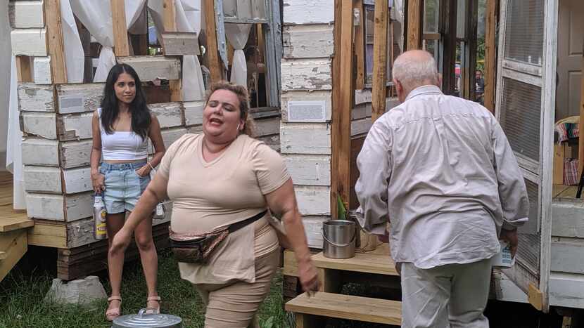 An audience member at the Artstillery immersive production "Family Dollar," left, watches a...