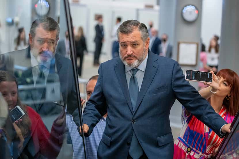 Sen. Ted Cruz, R-Texas, speaks with reporters as he heads to a vote on Capitol Hill,...