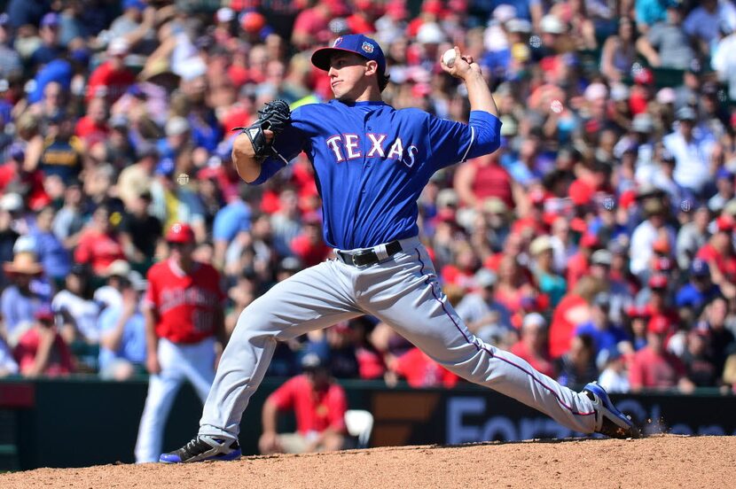 TEMPE, AZ - MARCH 13:  Derek Holland #45 of the Texas Rangers delivers a pitch in the second...