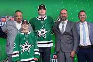 Lian Bichsel poses with Dallas Stars officials after being selected during  the first round...