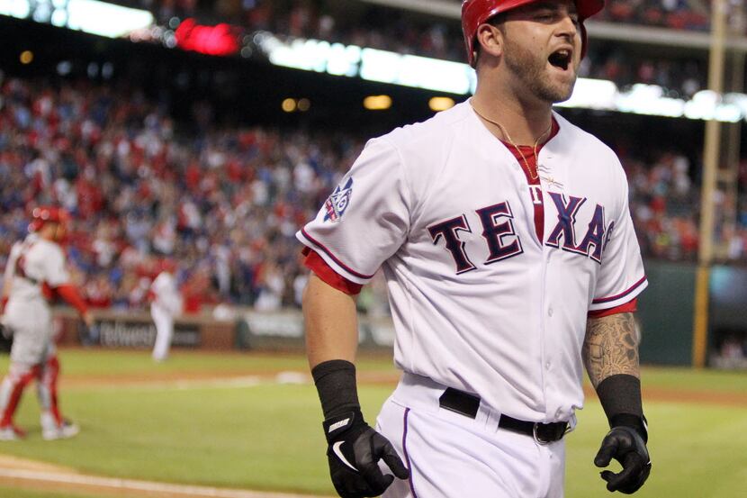 Texas catcher Mike Napoli heads to the dugout after hitting his third inning three-run homer...