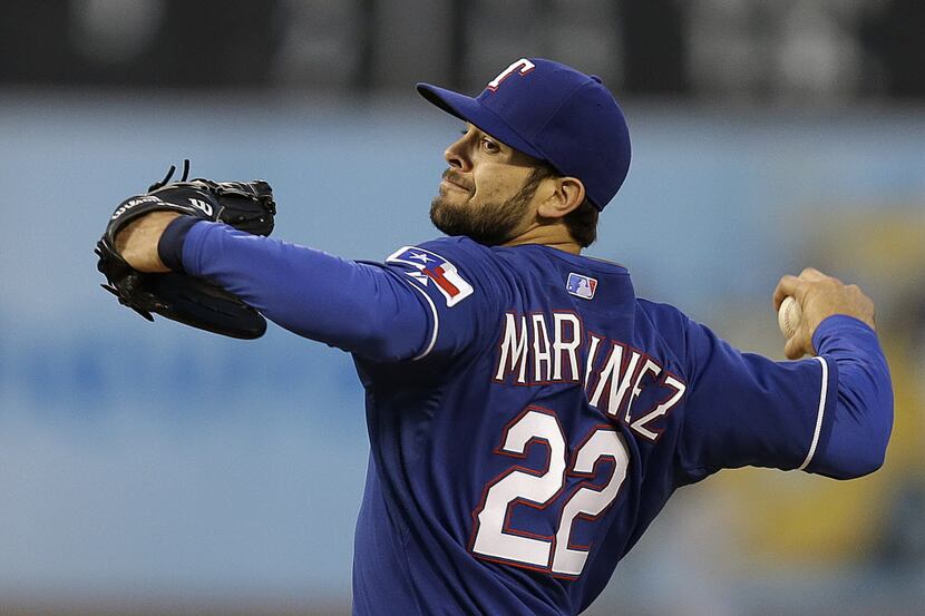 Texas Rangers pitcher Nick Martinez works against the Oakland Athletics in the first inning...