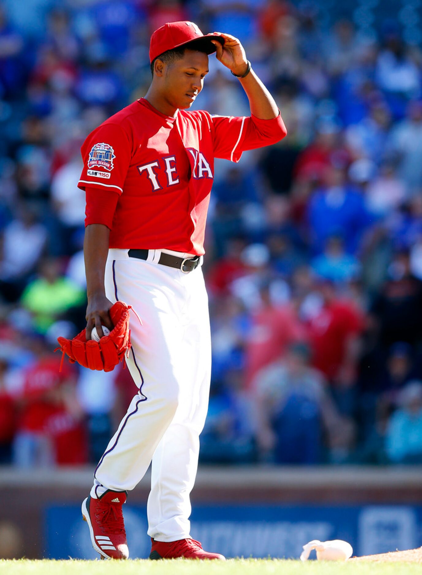 Texas Rangers relief pitcher Jose Leclerc reacts after giving up a ninth inning home run to...