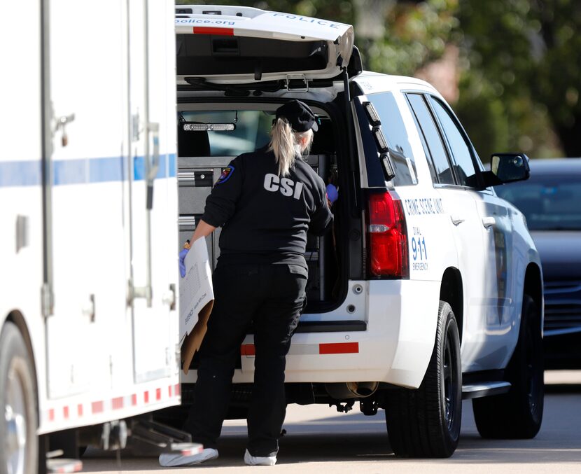 Authorities work at a home in Plano where two people were found dead Wednesday night.