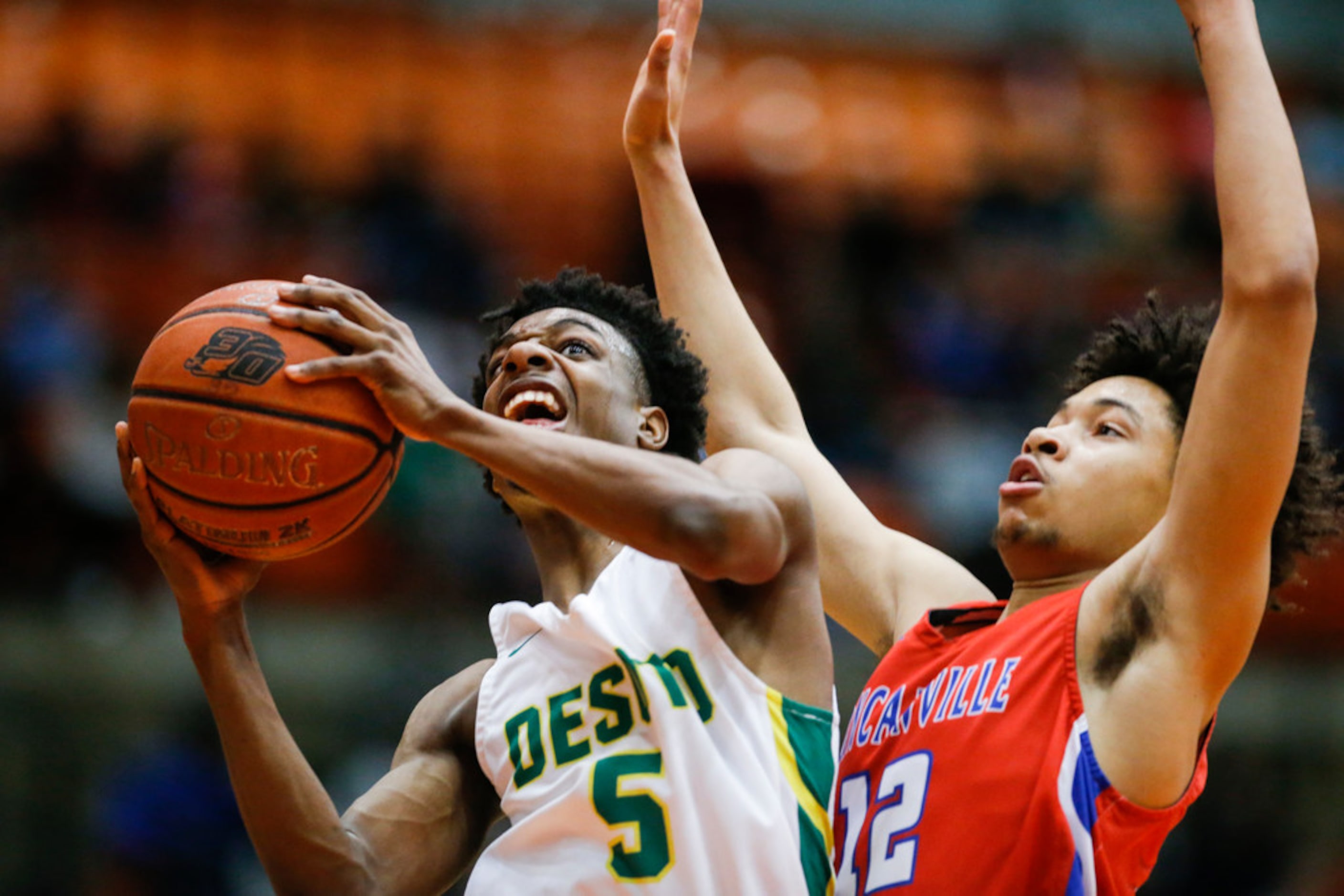 DeSoto senior guard Jarius Hicklen (5) attempts a shot as Duncanville senior guard Miles...