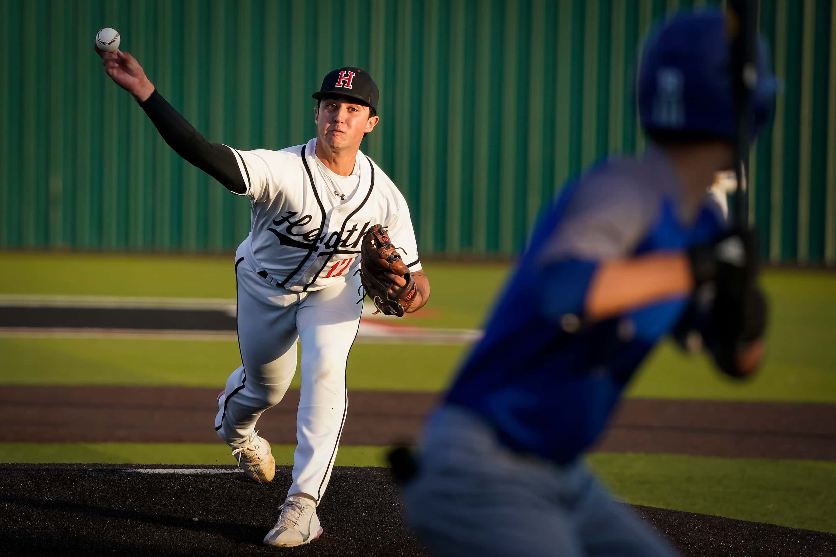 Rockwall-Heath pitcher Josh Hoover delivers to North Mesquite pitcher Kolby Long during a...