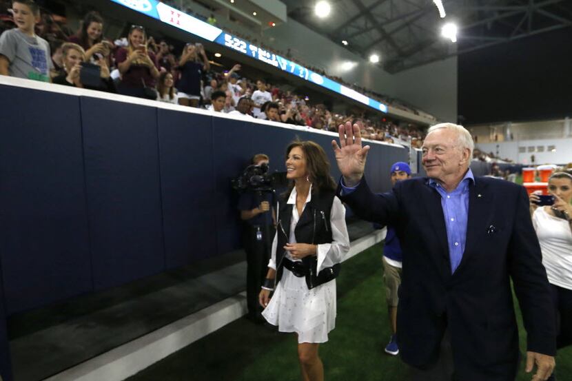Dallas Cowboys owner and general manager Jerry Jones waves to fans alongside his daughter...