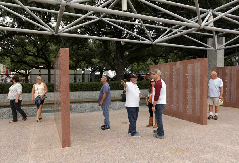 Vietnam veteran Tommy Acosta, center, talks to first-time fairgoers Ashley Servi and Chad...