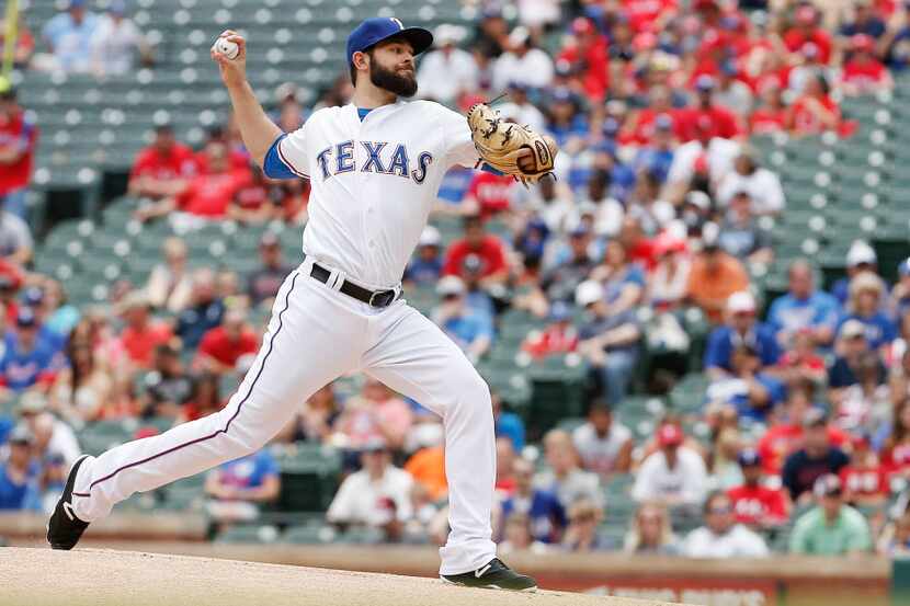 Texas Rangers starting pitcher Nick Martinez throws during the first inning of a baseball...