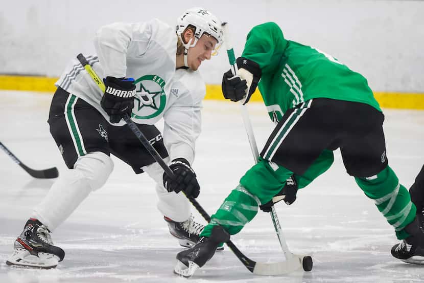 Dallas Stars centers Roope Hintz (left) and Joe Pavelski (right) set up for a face off...