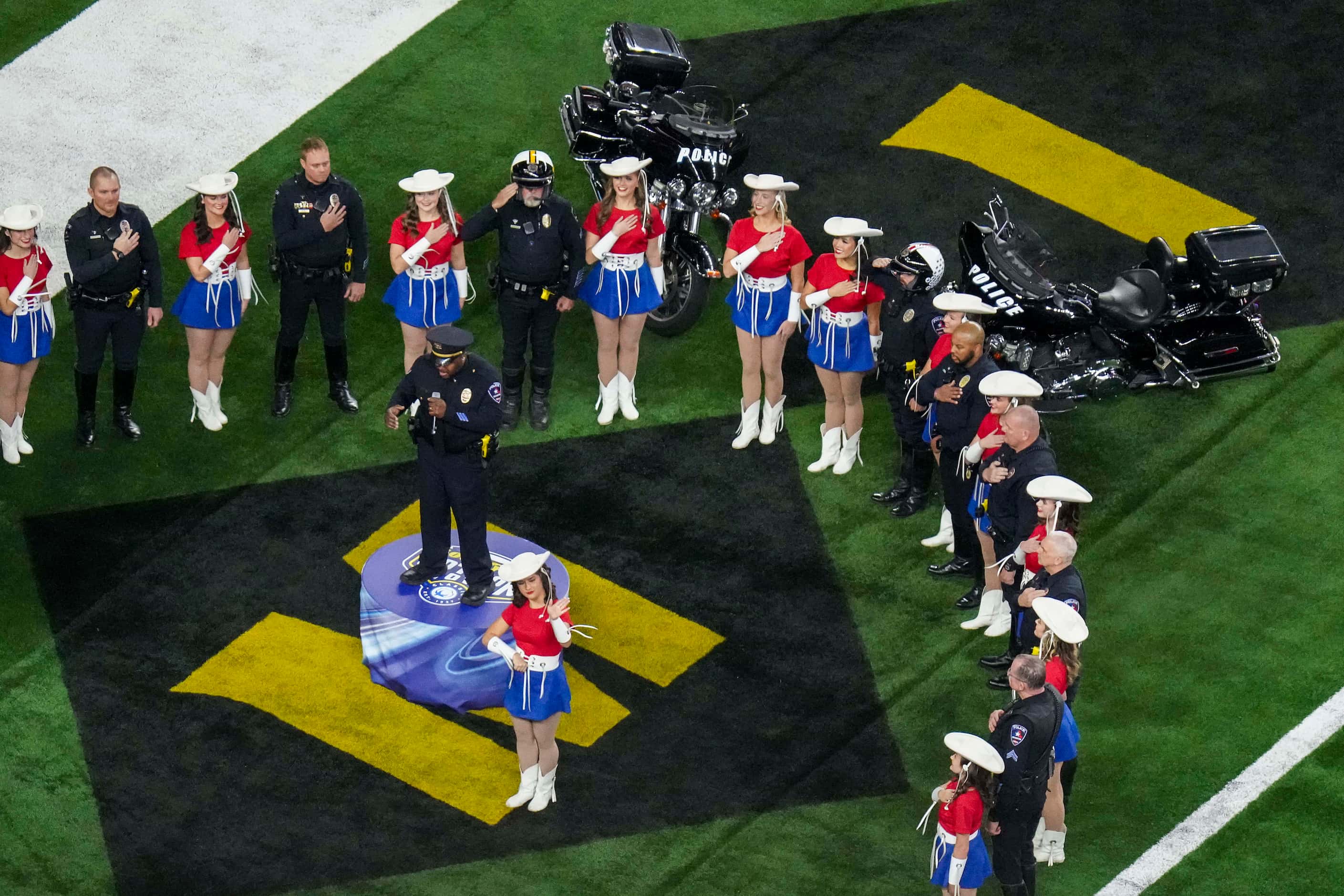 Arlington Police Lt. Ray Polk sings the national anthem before the Goodyear Cotton Bowl...
