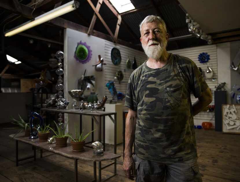 Jim Bowman, glasswork artist and owner of Bowman Glass, poses for a portrait in his studio...