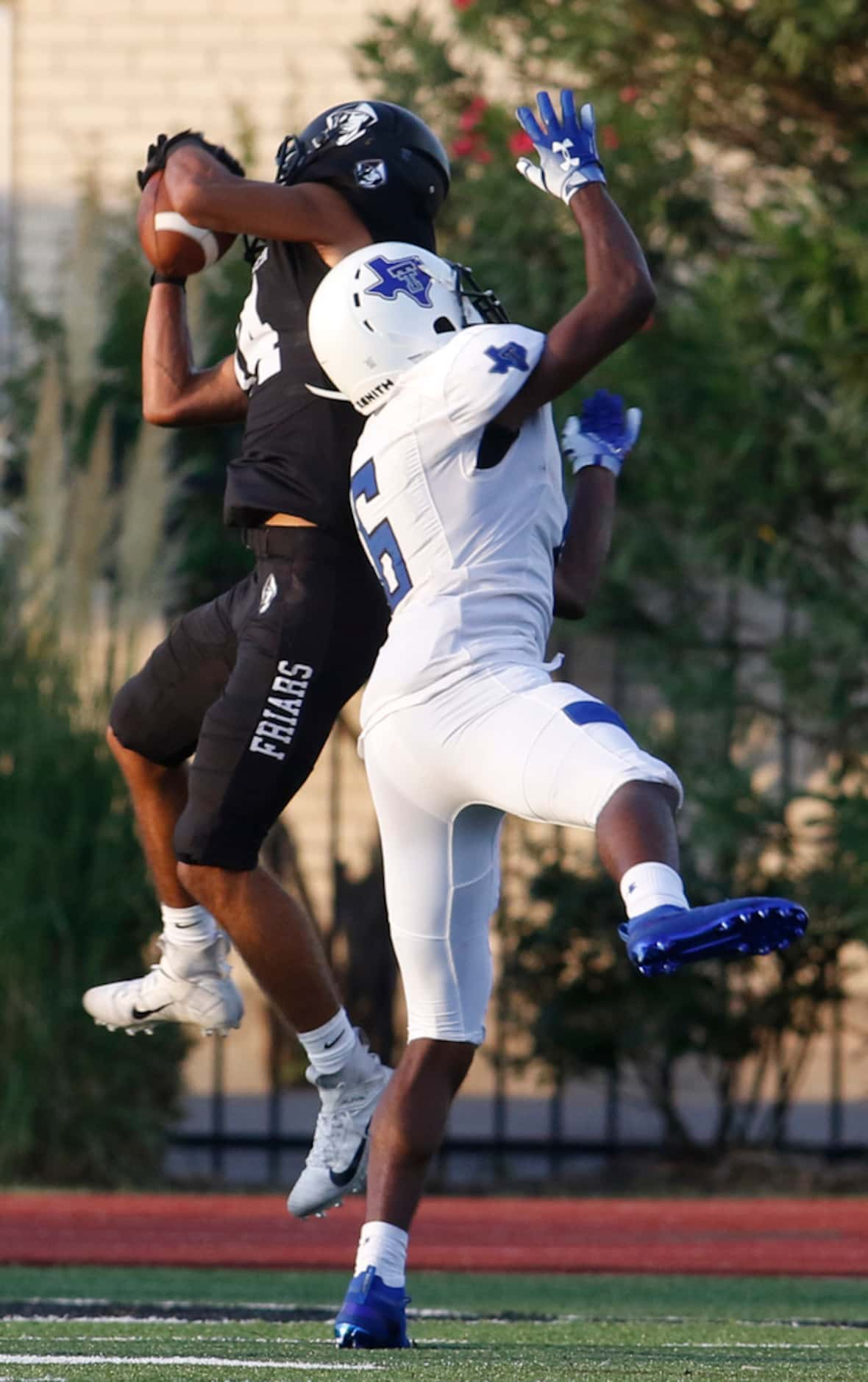 Bishop Lynch receiver Carlow Marquez (14) pulls in a touchdown pass over the defense of...