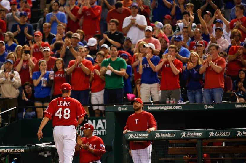 Texas Rangers starting pitcher Colby Lewis (48) gets a standing ovation from the fans after...