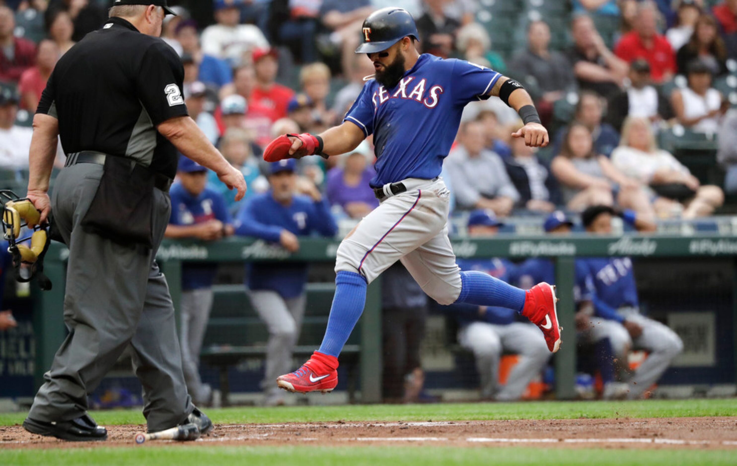 Texas Rangers' Rougned Odor scores against the Seattle Mariners in the second inning of a...