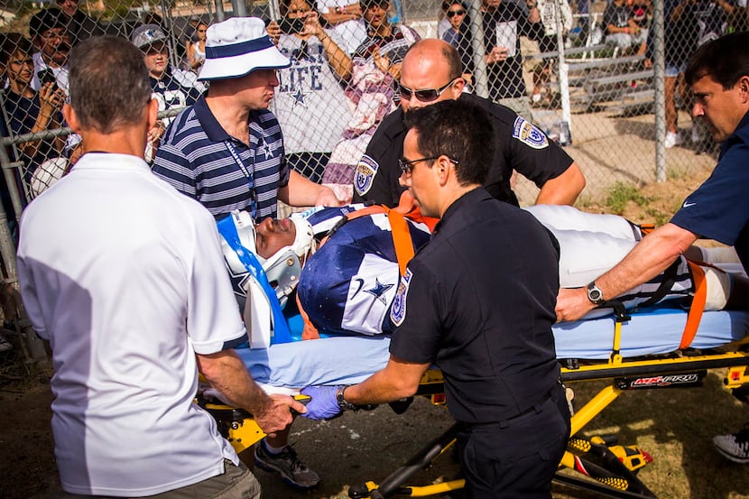 Dallas Cowboys defensive end Kenneth Boatright is taken to a waiting ambulance after being...