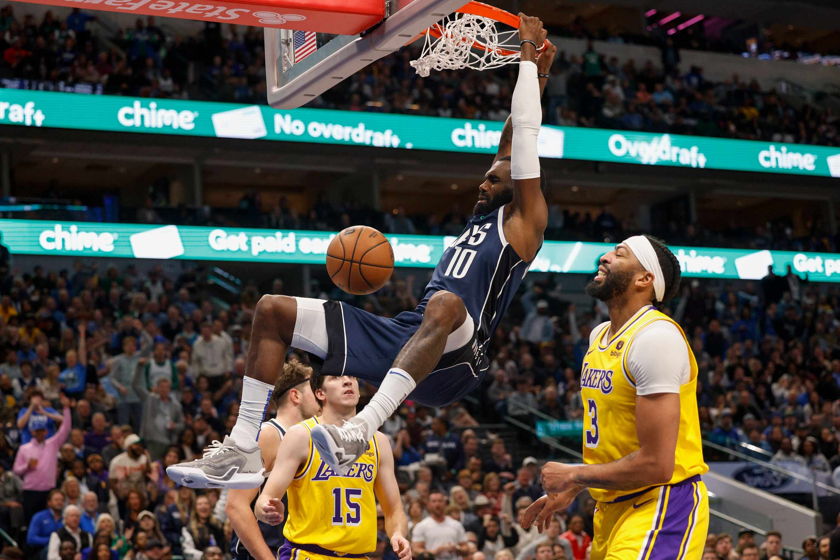 Dallas Mavericks forward Tim Hardaway Jr. (10) dunks the ball alongside Los Angeles Lakers...