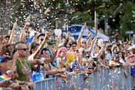Spectators cheer for beads during the St. Pete Pride festival on Saturday, June 22, 2024 in...