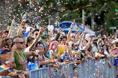 Spectators cheer for beads during the St. Pete Pride festival on Saturday, June 22, 2024 in...