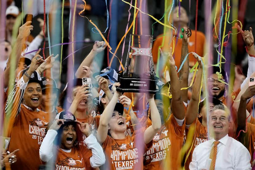Texas players celebrate after their NCAA college basketball game against Iowa State for the...