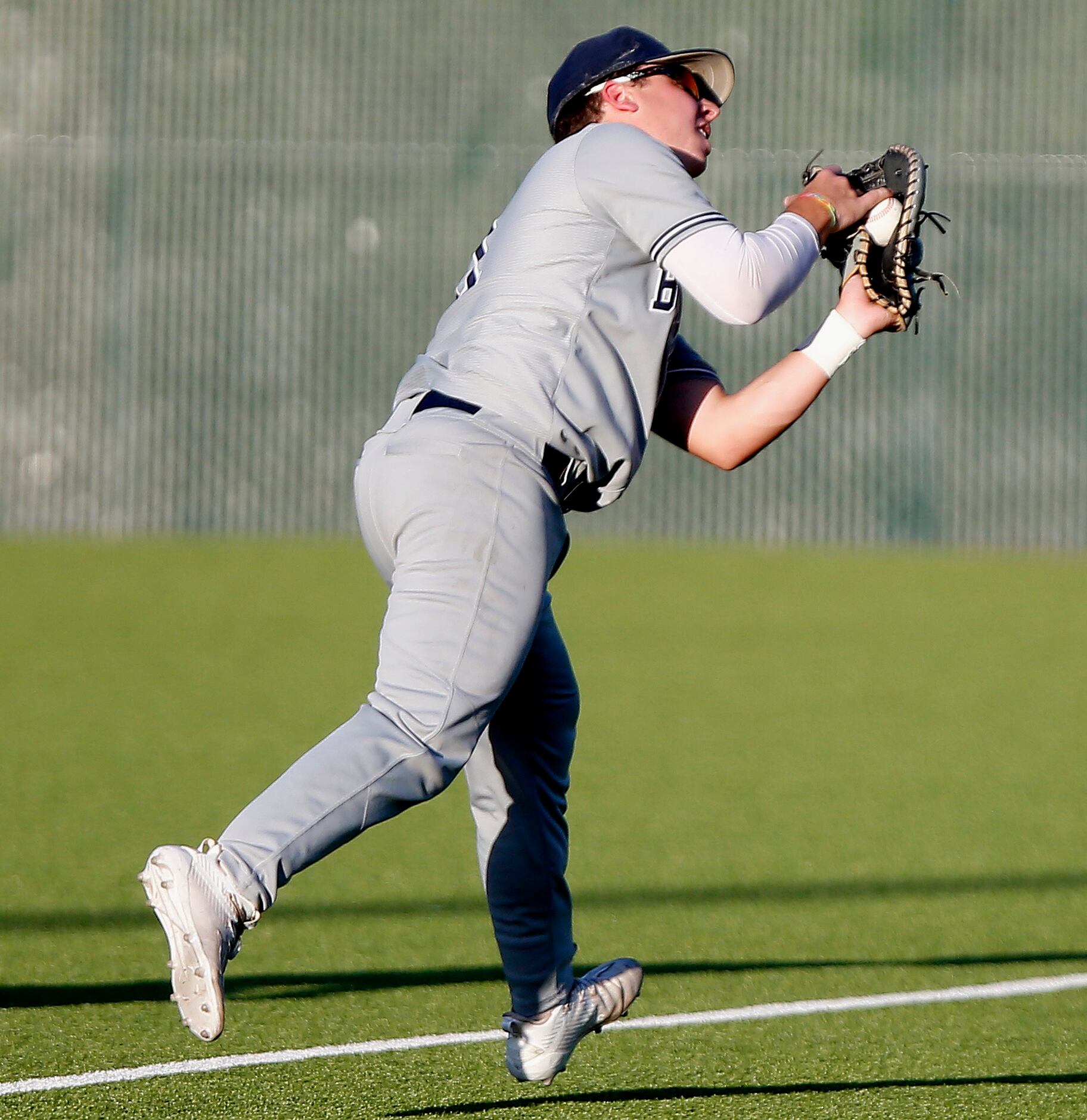 McKinney North High School Dylan Stowe (11) catches a pop up in foul territory to retire the...