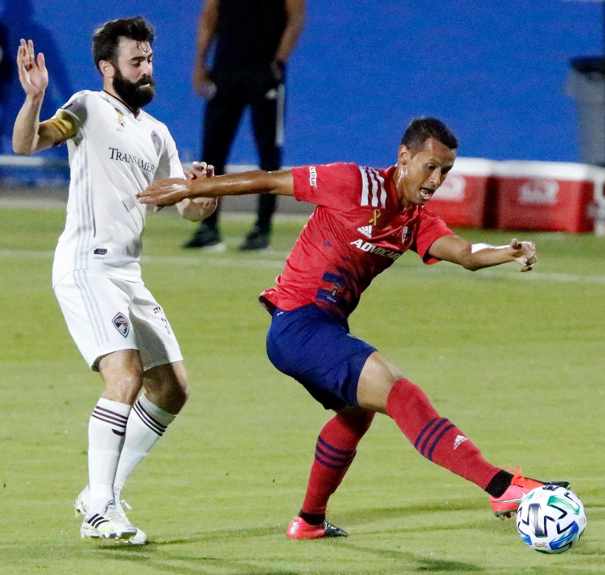 FC Dallas midfielder Pablo Aranguiz shields the soccer ball from Colorado Rapids midfielder...