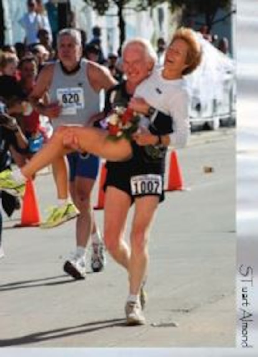 Ken Ashby carrying Linda Kelly after the pair got married during the 2005 Dallas White Rock...